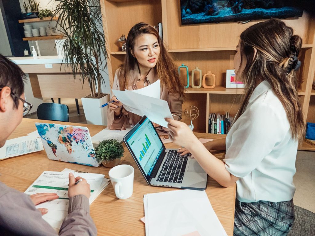 Professionals reviewing documents and charts in an office meeting