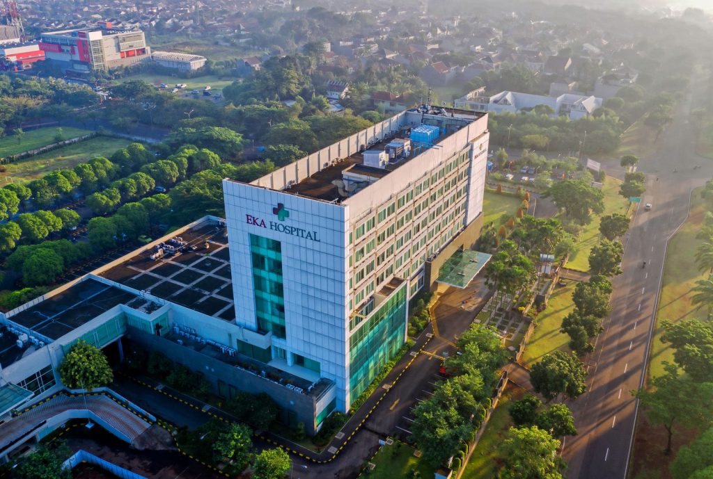 Aerial view of a white hospital building and surrounding area